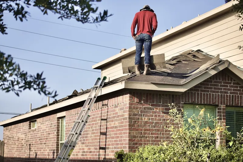 Professional roofer working on a residential roof in Bakersfield